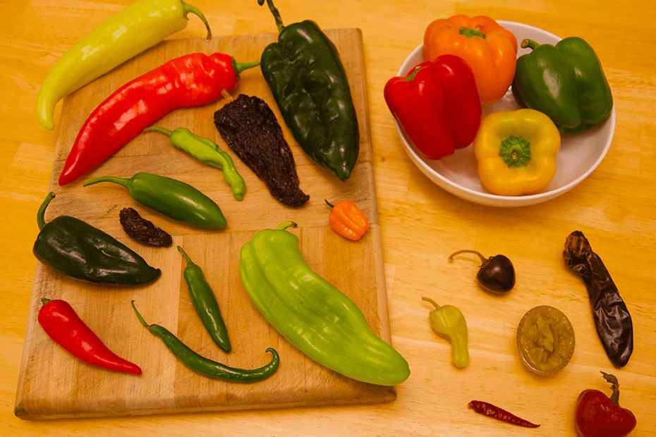 A variety of peppers spread out on a table © 2021 S. Christopher Stroupe