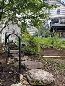 Walkway made of large stone steps and arched hand railing.